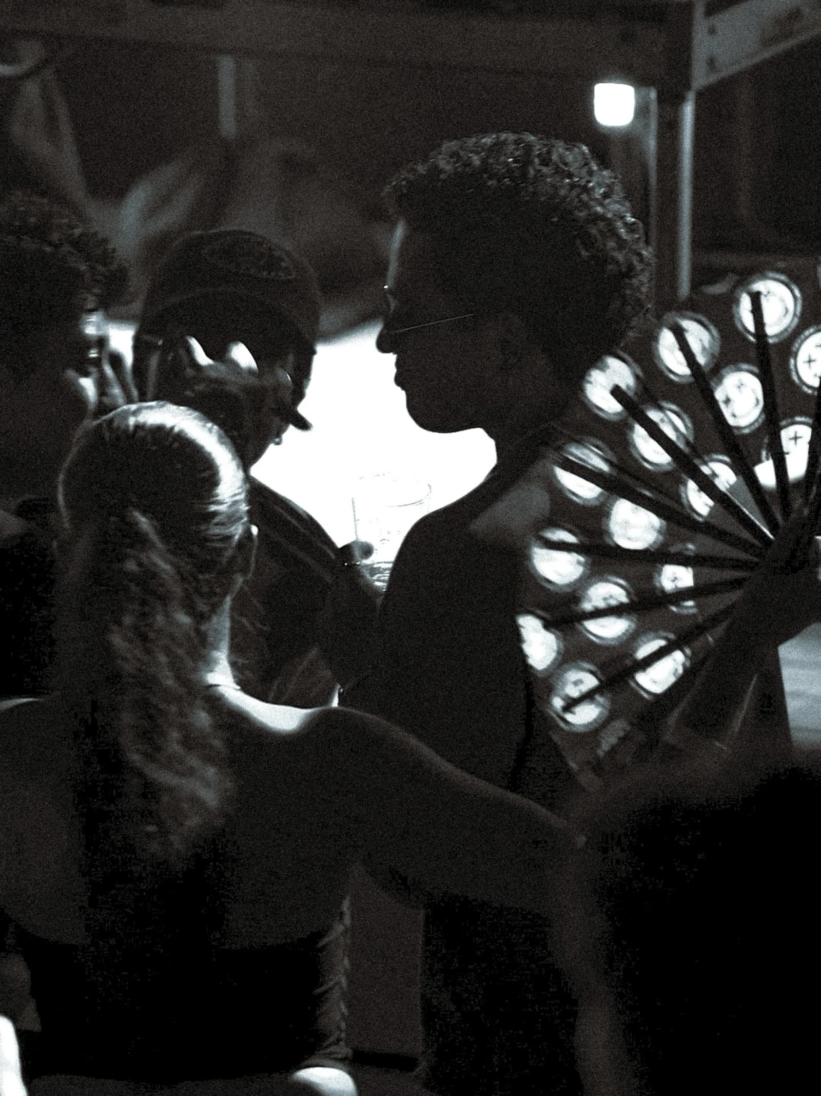 The floor at The Cut in black and white, faces lit by a bank of blinders